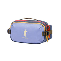 A blue hip pack with yellow trim and a white logo, featuring multiple compartments and side compression straps.